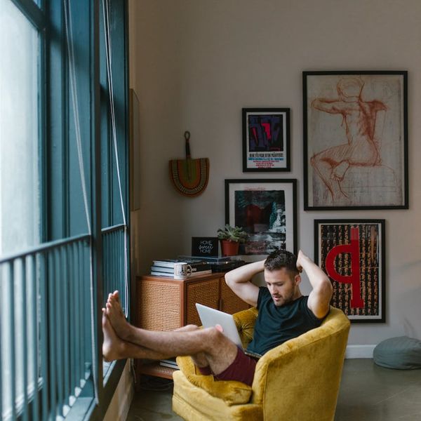 Person sitting comfortably by a window, taking a mindful break from work.